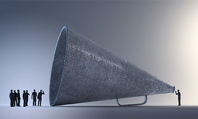 a man standing next to a megaphone