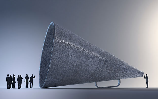 a man standing next to a large megaphone