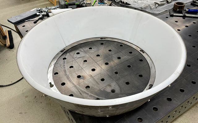 a white bowl with holes in it